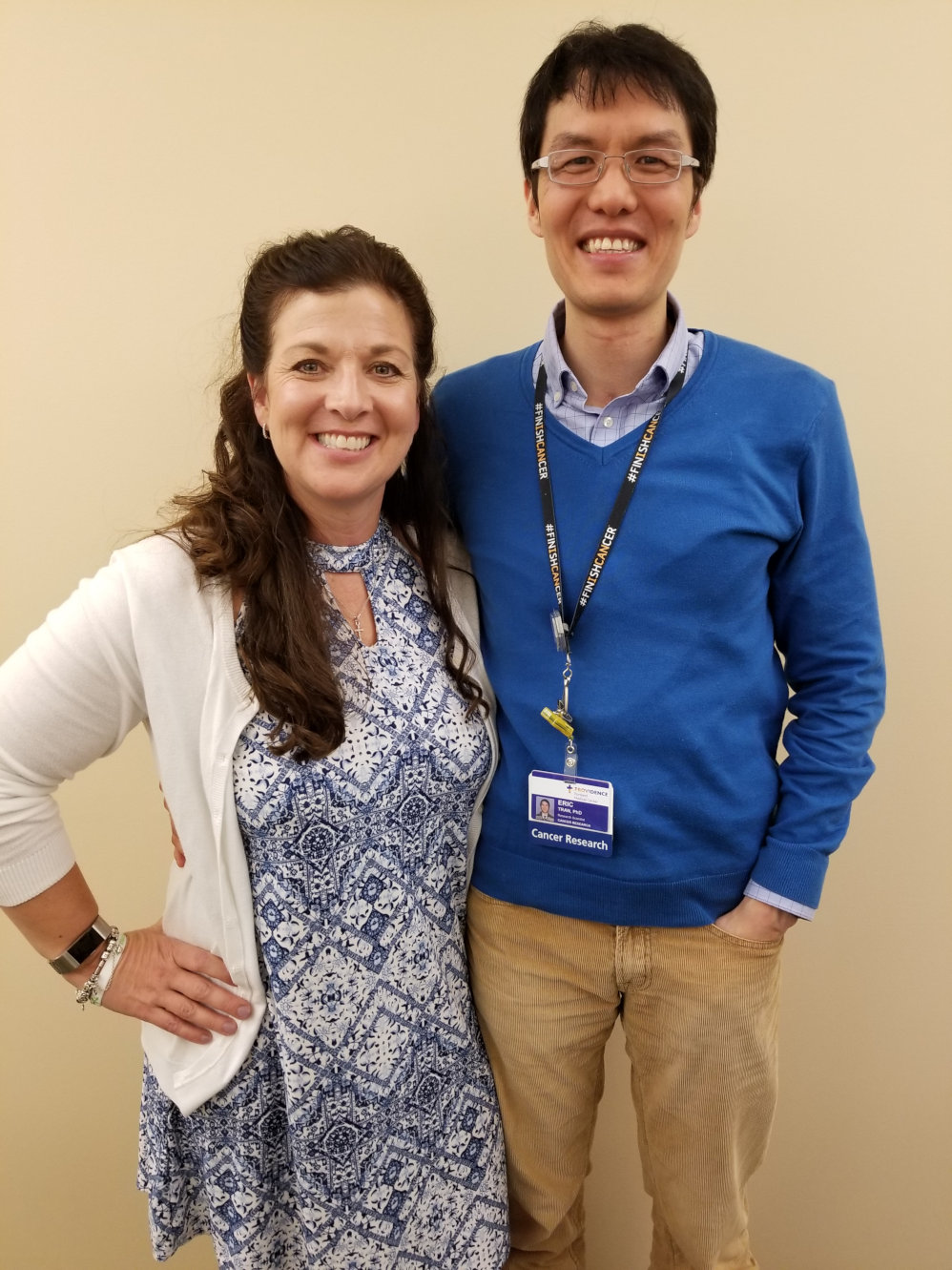 Melinda standing next to her doctor Eric Tran, both smiling